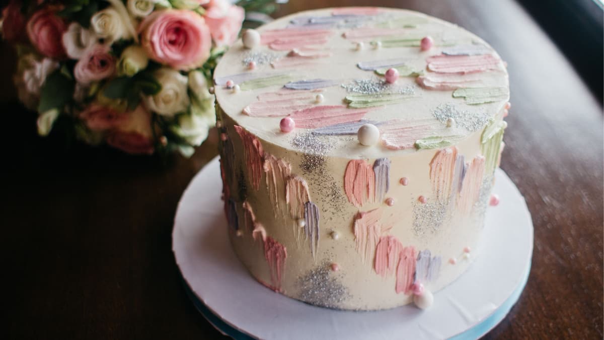 Pastel palette-knife painted cake decorated with sugar pearls